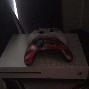 An Xbox with 2 controllers